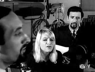 Jack Benny's guests, the folk group Peter, Paul & Mary, illustrate how ...